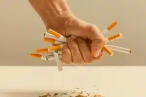 Hand crushing cigarettes with stress